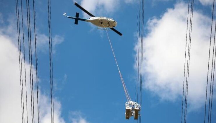 helikoptere bağlı sepetle elektrik iletim hatlarına bakım yaparken ölüme meydan okuyorlar